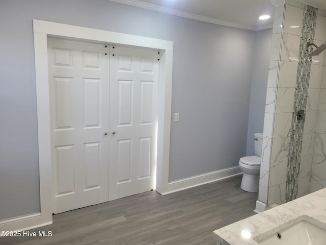 4384 Race Track Rd, Grifton, NC 28530 - bathroom featuring crown molding, toilet, baseboards, wood finished floors, and tiled shower