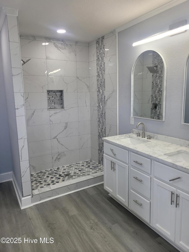 4384 Race Track Rd, Grifton, NC 28530 - full bathroom with wood finished floors, a tile shower, double vanity, and baseboards