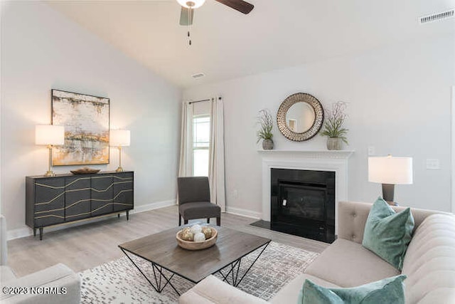 913 Bee Tree Ct, New Bern, NC 28560 - living room featuring a ceiling fan, wood finished floors, a fireplace with flush hearth, lofted ceiling, and baseboards