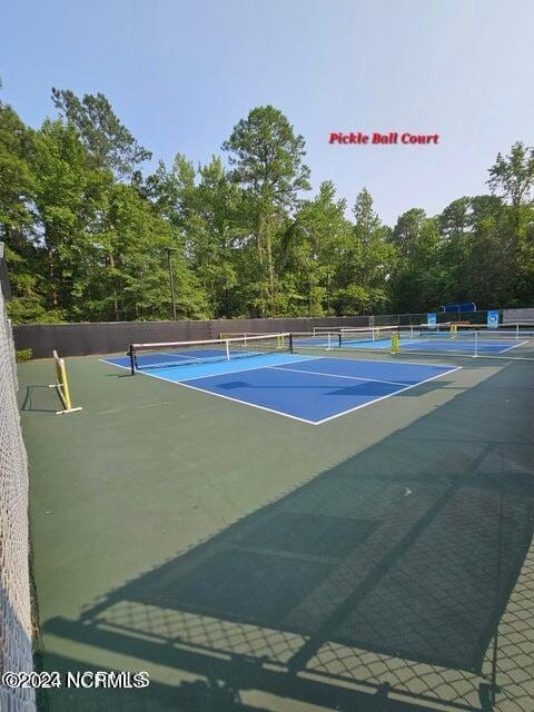 913 Bee Tree Ct, New Bern, NC 28560 - view of tennis court with fence and view of wooded area