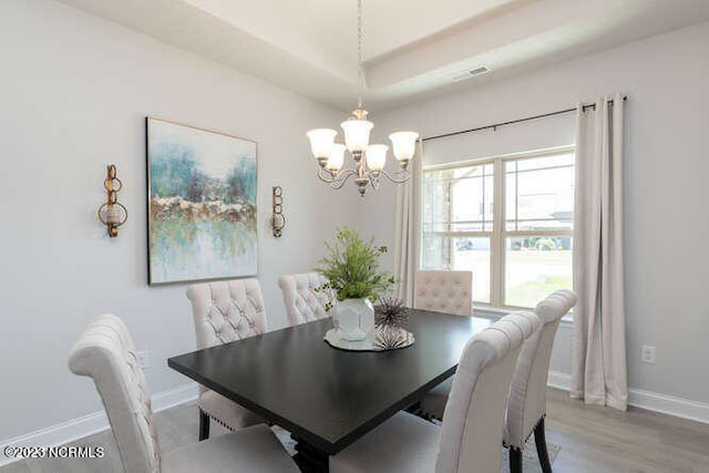 913 Bee Tree Ct, New Bern, NC 28560 - dining space featuring a chandelier, baseboards, and light wood-type flooring