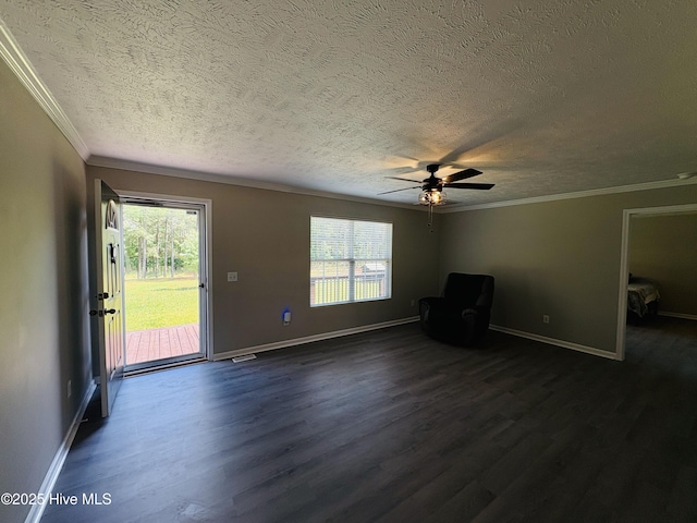 106 Haywood Country Dr, Mount Gilead, NC 27306 - unfurnished living room featuring a textured ceiling, dark wood-type flooring, ornamental molding, ceiling fan, and baseboards