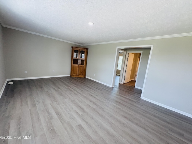 106 Haywood Country Dr, Mount Gilead, NC 27306 - unfurnished room featuring baseboards, wood finished floors, crown molding, and a textured ceiling