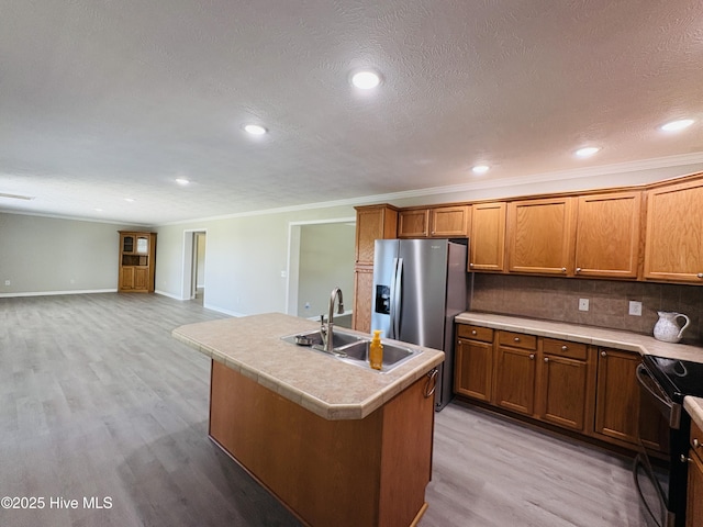 106 Haywood Country Dr, Mount Gilead, NC 27306 - kitchen with a sink, stainless steel fridge, black / electric stove, light wood-style flooring, and brown cabinets