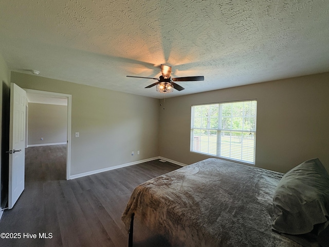 106 Haywood Country Dr, Mount Gilead, NC 27306 - bedroom with dark wood finished floors, baseboards, a textured ceiling, and ceiling fan