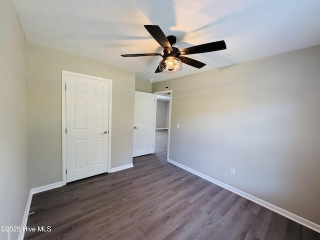 106 Haywood Country Dr, Mount Gilead, NC 27306 - unfurnished bedroom featuring dark wood-type flooring, baseboards, and a ceiling fan