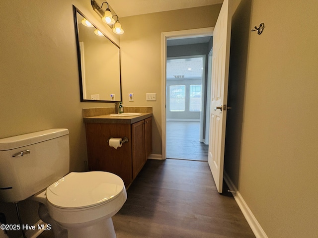 106 Haywood Country Dr, Mount Gilead, NC 27306 - half bath featuring wood finished floors, toilet, vanity, and baseboards
