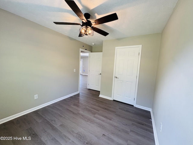 106 Haywood Country Dr, Mount Gilead, NC 27306 - unfurnished bedroom featuring dark wood-type flooring, baseboards, a ceiling fan, and a textured ceiling