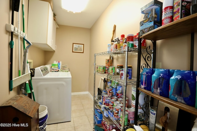 clothes washing area with tile patterned floors, independent washer and dryer, and baseboards