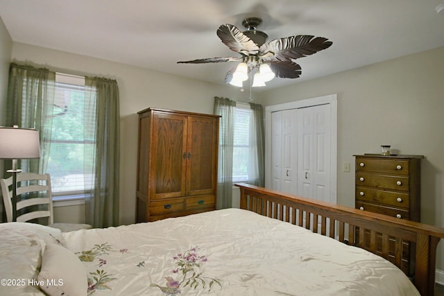 bedroom featuring multiple windows, a closet, and ceiling fan