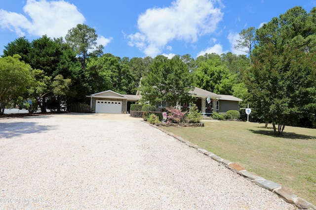 view of front of home with driveway, a garage, and a front yard
