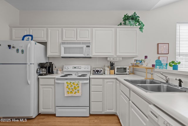881 Great Egret Cir SW Unit 59E, Sunset Beach, NC 28468 - kitchen featuring white appliances, a sink, white cabinetry, and light wood-type flooring