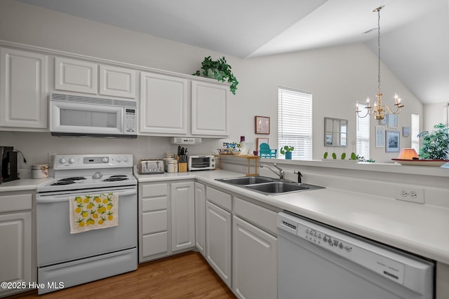 881 Great Egret Cir SW Unit 59E, Sunset Beach, NC 28468 - kitchen with white appliances, a sink, lofted ceiling, white cabinetry, and light countertops