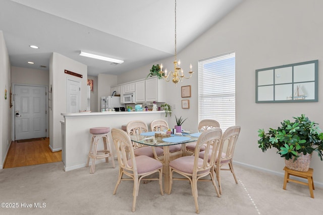 881 Great Egret Cir SW Unit 59E, Sunset Beach, NC 28468 - dining space with a chandelier, baseboards, light carpet, lofted ceiling, and recessed lighting