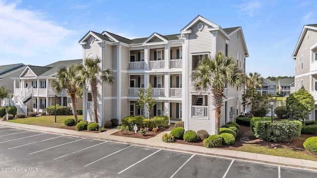 881 Great Egret Cir SW Unit 59E, Sunset Beach, NC 28468 - view of building exterior featuring uncovered parking and a residential view