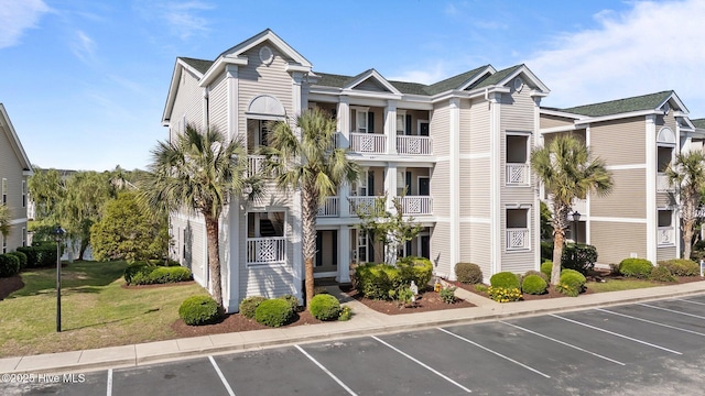 881 Great Egret Cir SW Unit 59E, Sunset Beach, NC 28468 - view of building exterior featuring uncovered parking