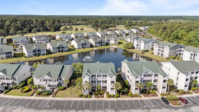 881 Great Egret Cir SW Unit 59E, Sunset Beach, NC 28468 - aerial view of residential area with a nearby body of water and a heavily wooded area