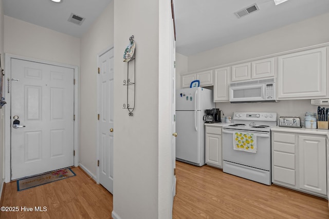 881 Great Egret Cir SW Unit 59E, Sunset Beach, NC 28468 - kitchen featuring white appliances, light wood-type flooring, white cabinets, and light countertops