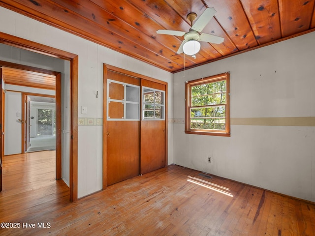 204 Cedar St, Emerald Isle, NC 28594 - unfurnished bedroom with hardwood / wood-style flooring, a closet, wooden ceiling, and wood walls