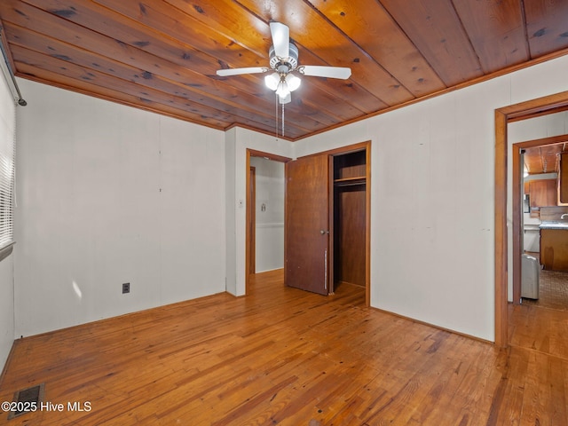 204 Cedar St, Emerald Isle, NC 28594 - unfurnished bedroom featuring hardwood / wood-style floors, wooden ceiling, a closet, and a ceiling fan