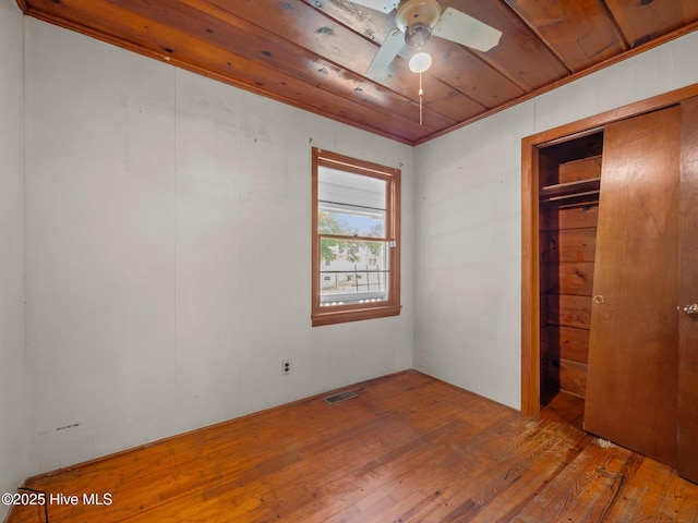 204 Cedar St, Emerald Isle, NC 28594 - unfurnished bedroom featuring hardwood / wood-style flooring, wood ceiling, and a closet