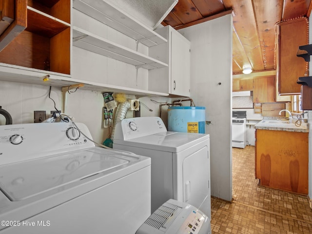204 Cedar St, Emerald Isle, NC 28594 - laundry room featuring electric water heater, separate washer and dryer, and cabinet space