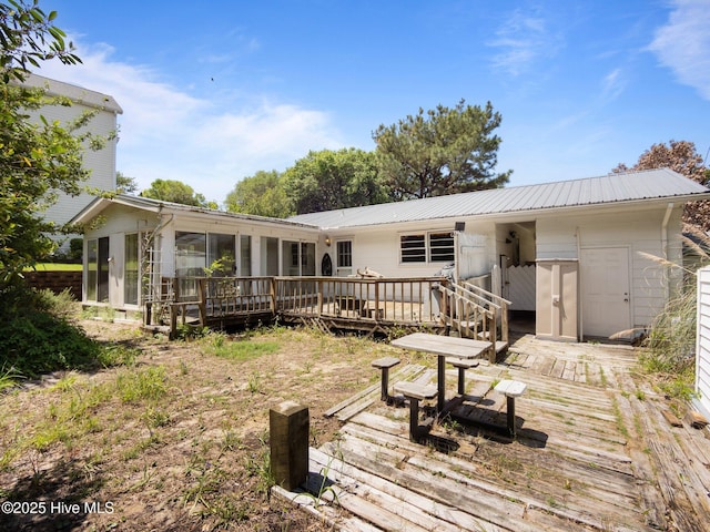 204 Cedar St, Emerald Isle, NC 28594 - rear view of house with a wooden deck, a sunroom, and metal roof