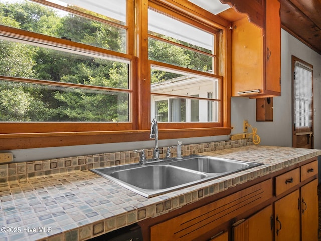 204 Cedar St, Emerald Isle, NC 28594 - kitchen featuring tile countertops, a sink, and healthy amount of natural light