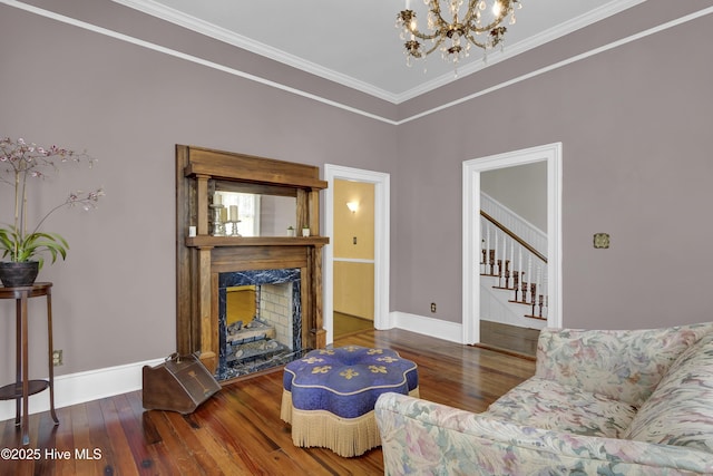 211 Ann St, Wilmington, NC 28401 - living area featuring a chandelier, wood finished floors, stairway, crown molding, and baseboards