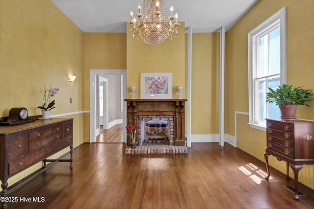 211 Ann St, Wilmington, NC 28401 - living room with plenty of natural light, hardwood / wood-style floors, a chandelier, and a stone fireplace