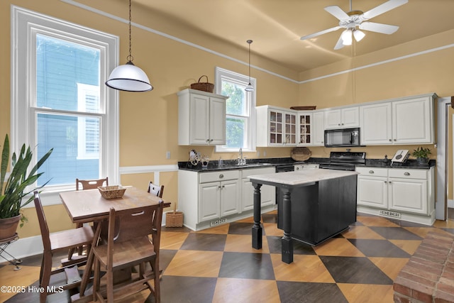 211 Ann St, Wilmington, NC 28401 - kitchen featuring black appliances, a sink, white cabinetry, and glass insert cabinets