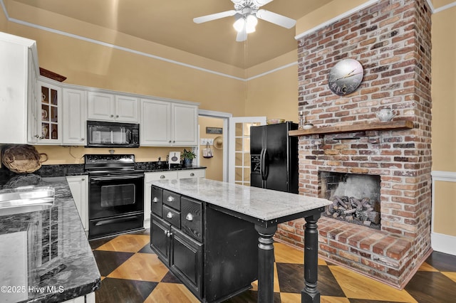 211 Ann St, Wilmington, NC 28401 - kitchen with black appliances, dark cabinets, white cabinets, wood finished floors, and a ceiling fan