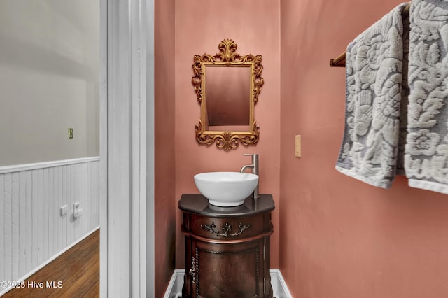 211 Ann St, Wilmington, NC 28401 - bathroom featuring wood finished floors, vanity, and wainscoting