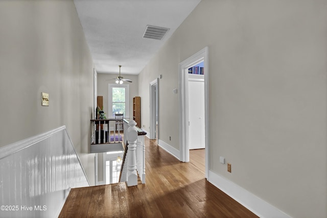 211 Ann St, Wilmington, NC 28401 - corridor featuring an upstairs landing, wood finished floors, and baseboards