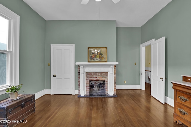 211 Ann St, Wilmington, NC 28401 - living area featuring wood finished floors, baseboards, ceiling fan, and a brick fireplace