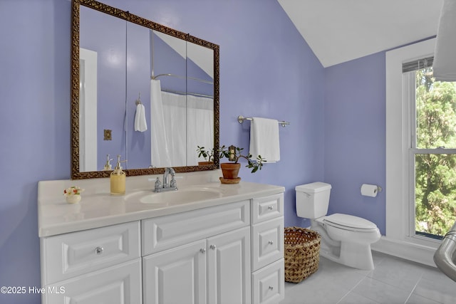 211 Ann St, Wilmington, NC 28401 - full bath with vaulted ceiling, toilet, vanity, tile patterned floors, and baseboards