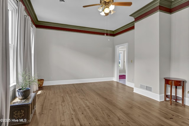 211 Ann St, Wilmington, NC 28401 - empty room with a ceiling fan, baseboards, wood finished floors, and crown molding