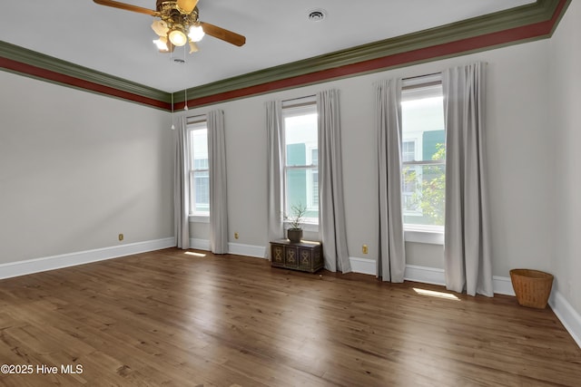 211 Ann St, Wilmington, NC 28401 - spare room featuring ceiling fan, wood finished floors, crown molding, and baseboards
