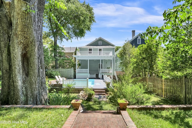 211 Ann St, Wilmington, NC 28401 - back of property featuring a fenced backyard, a balcony, and a sunroom