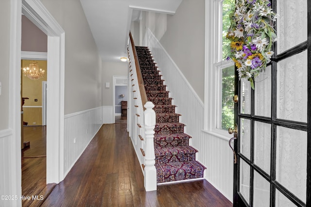 211 Ann St, Wilmington, NC 28401 - stairs featuring wainscoting, hardwood / wood-style flooring, and a chandelier