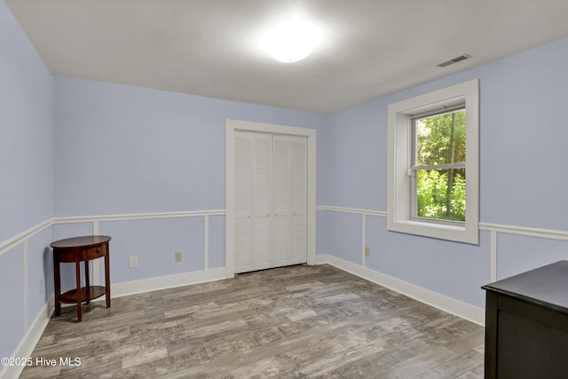 211 Ann St, Wilmington, NC 28401 - unfurnished bedroom with wood finished floors, a closet, and baseboards