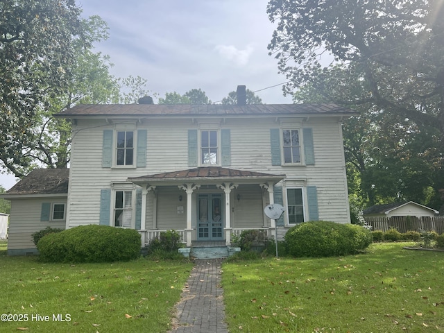view of front of home with a porch, french doors, and a chimney