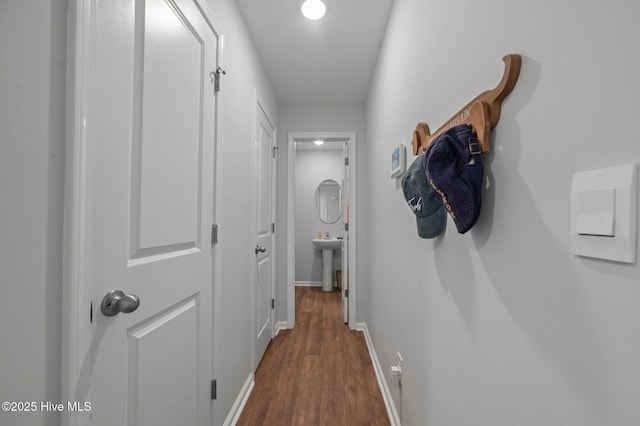 4569 Sandstone Dr, Greenville, NC 27858 - corridor featuring dark wood-style floors, baseboards, and a sink