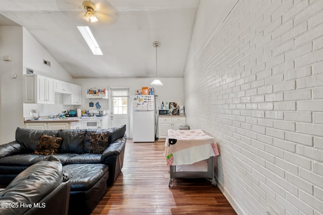 1119 Park St 1117, Elizabeth City, NC 27909 - living area with wood finished floors, a skylight, ceiling fan, brick wall, and high vaulted ceiling