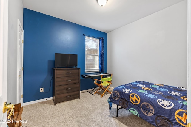 carpeted bedroom featuring baseboards