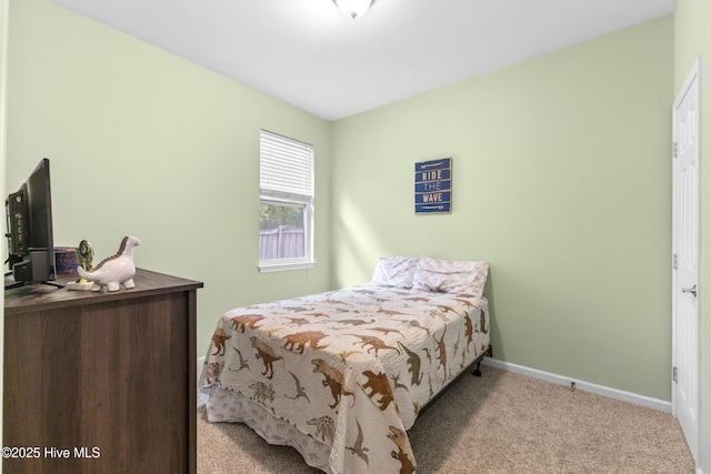 carpeted bedroom featuring baseboards