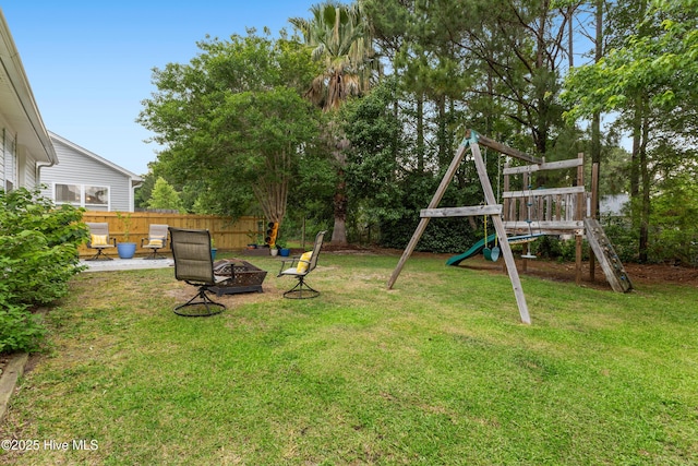 view of yard featuring a playground and a fire pit