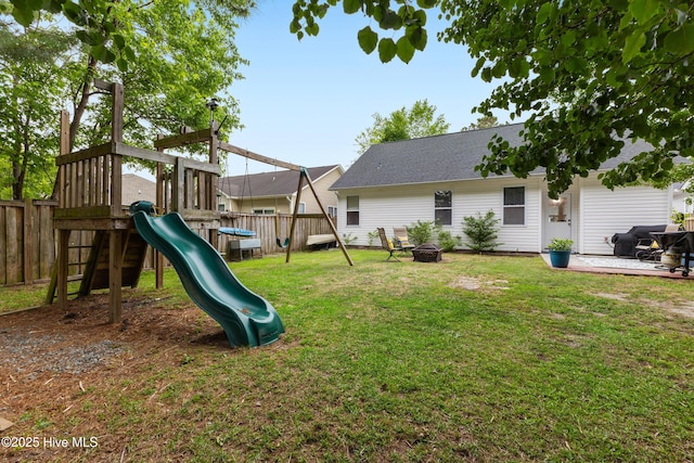 view of yard with a playground and an outdoor fire pit