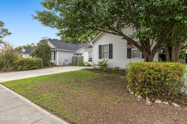 ranch-style home with driveway and fence
