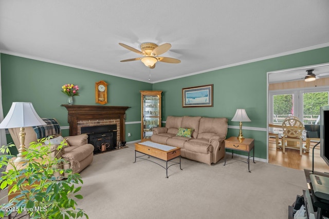 carpeted living room featuring ceiling fan, ornamental molding, and baseboards
